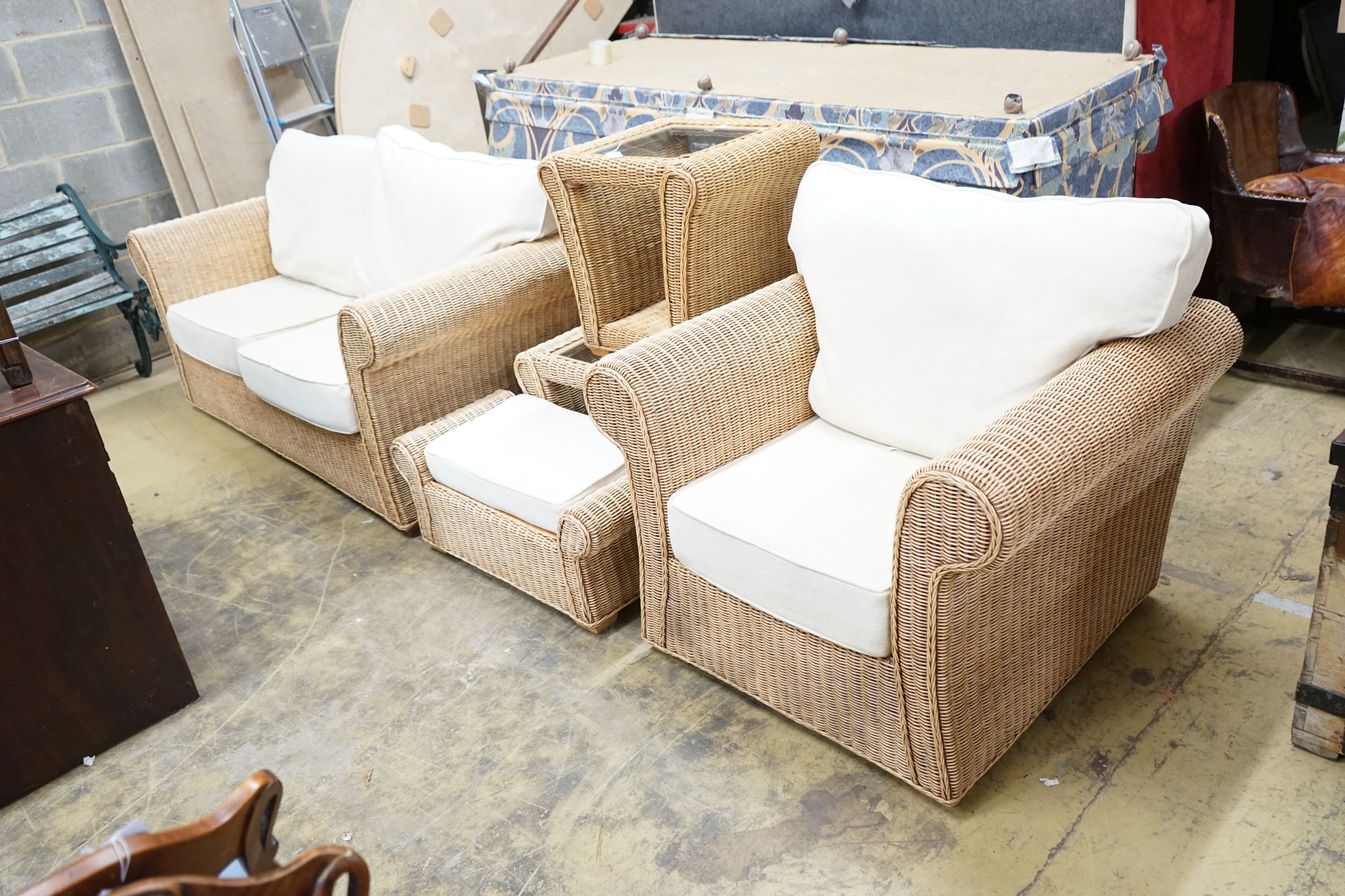 A rattan conservatory suite comprising two seater settee, length 180cm, depth 85cm, height 184cm, armchair, footstool and two glass topped tables